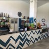 Bancone di un bar moderno con motivo a zigzag blu, bottiglie esposte e snack.